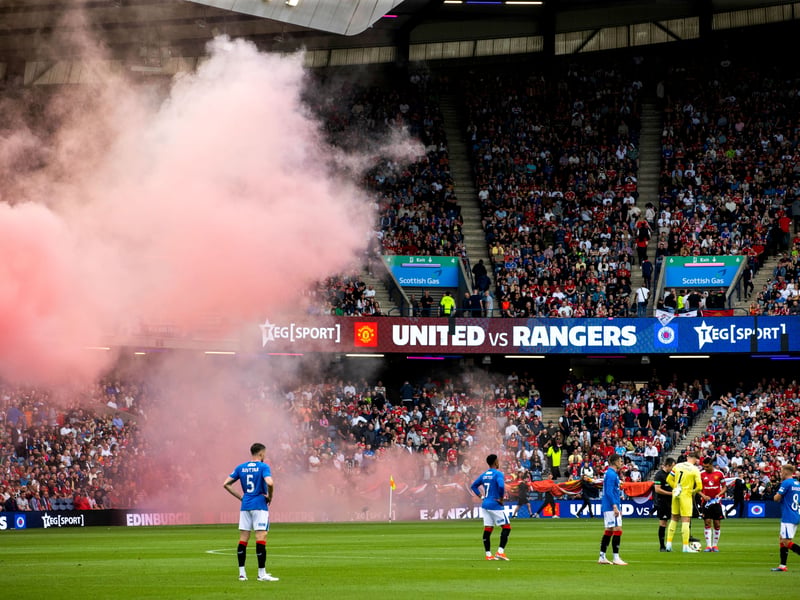 Fans get the atmosphere going ahead of the game between Rangers and Manchester United.