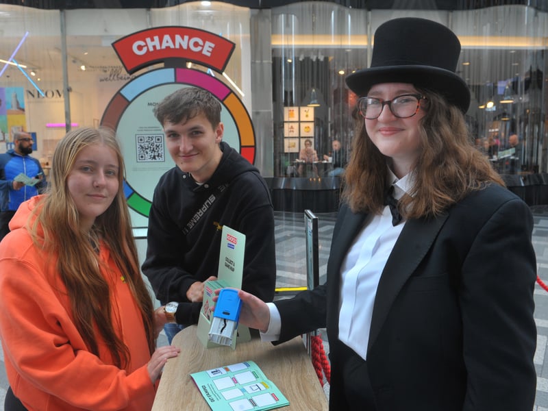 Jade Greenwood and Kieran Harris get their map stamped by Mr Monopoly after completing the crossword in Victoria Gate.