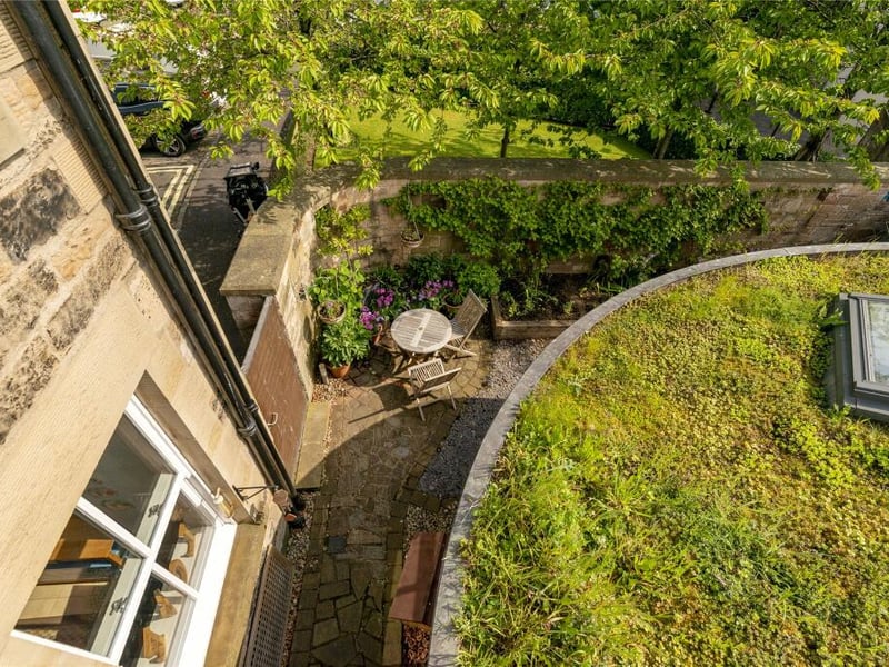 The house has a copper clad curved extension with a sedum green roof.