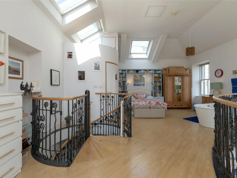 The principal bedroom suite is on a curved mezzanine level accessed from the spiral staircase and features a free-standing bath, a fully tiled ensuite shower room and double doors leading to a South facing balcony.
