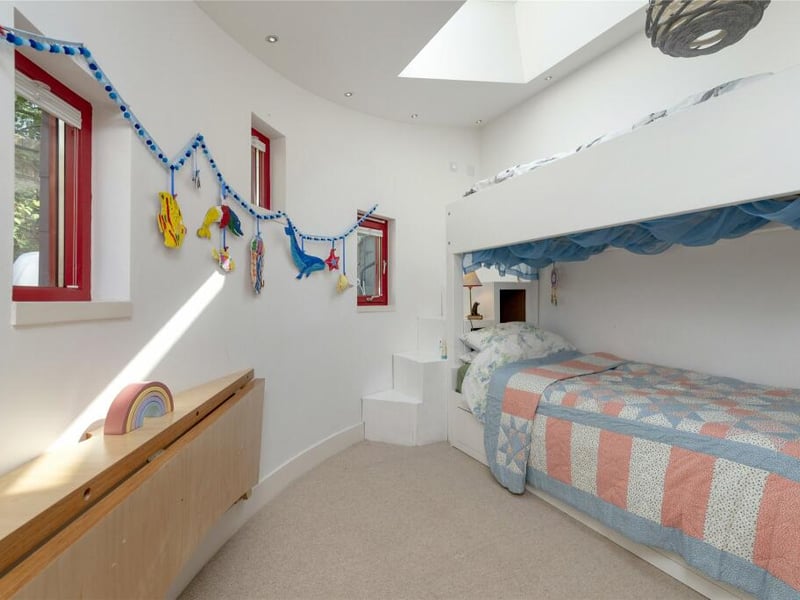 The extension houses a second bedroom, and a shower room.