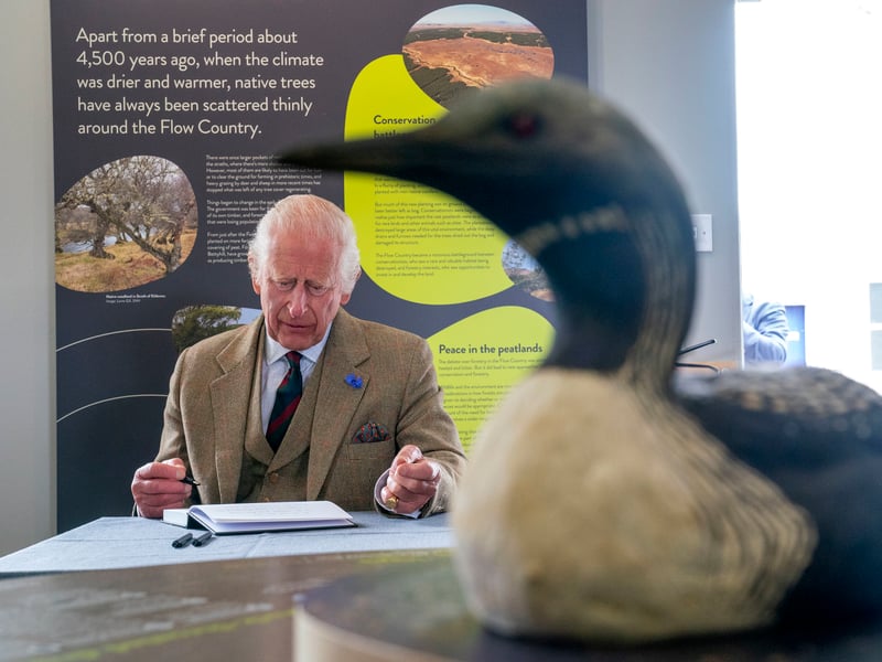 King Charles III signs the visitors book