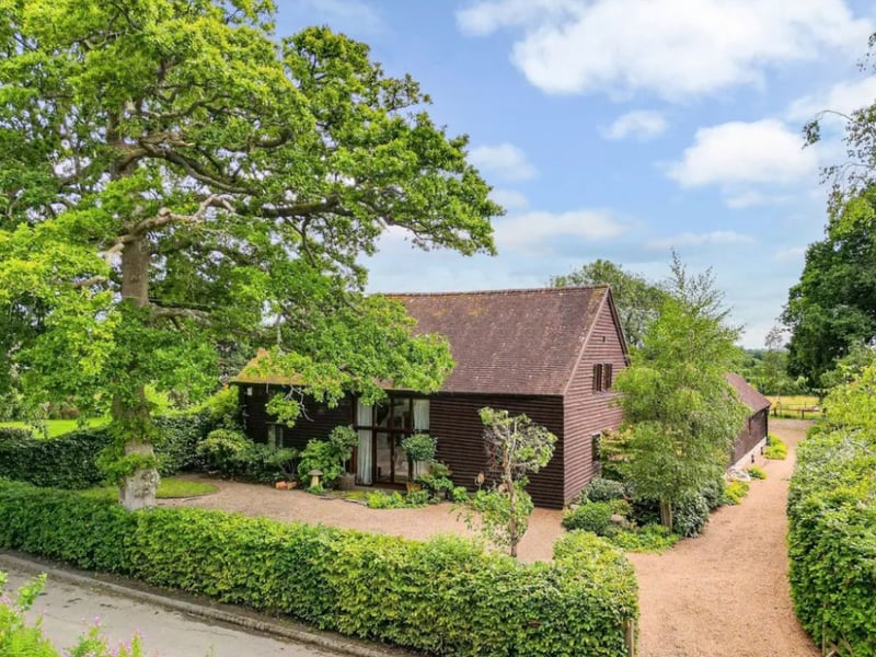 The listing says: "With a perfect combination of charm and character, as well a layout that offers both versatility and flexibility for any growing family, Clarendon Barn is surrounded by countryside and comes with approaching one and a half acres of mature gardens with two adjoining paddocks."