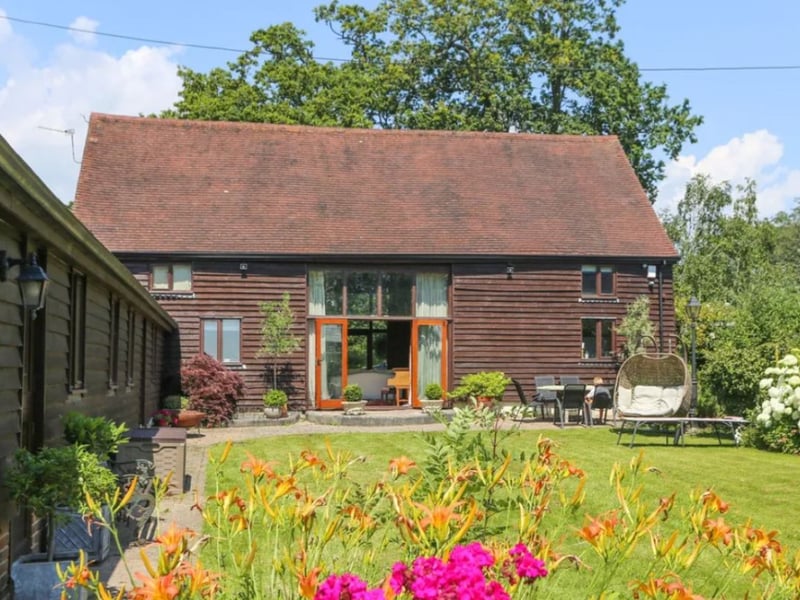 This stunning home comes with five bedrooms, three bathrooms and four reception rooms. 