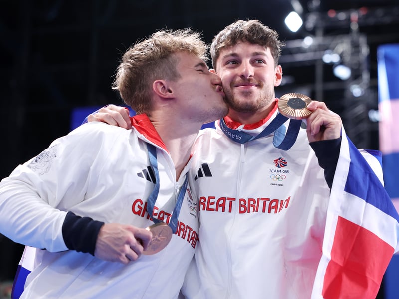 Jack Laugher giving his teammate a kiss on the cheek after completing with 438.15 points. 