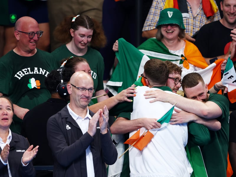 Daniel Wiffen is pictured celebrating his gold medal with family and friends.
