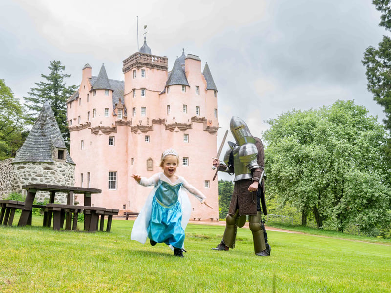 A young girl dressed as a princess playing in the restored grounds of Craigievar Castle, in Aberdeenshire, which is said to have inspired Walt Disney's Cinderella Castle