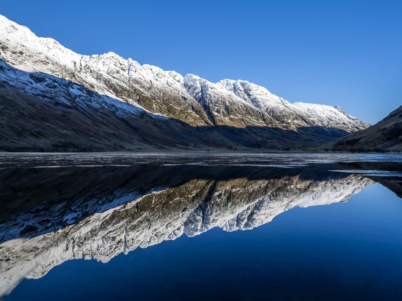 The snow covered peaks in Glencoe reflected in Loch Achtriochtan