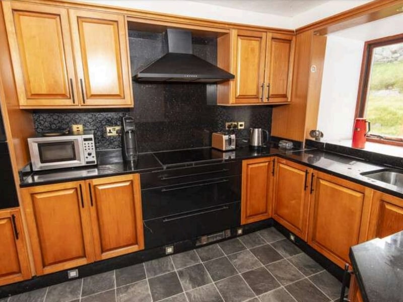 A photo of the kitchen. The ground floor also includes a shower room, the cinema room and two porches