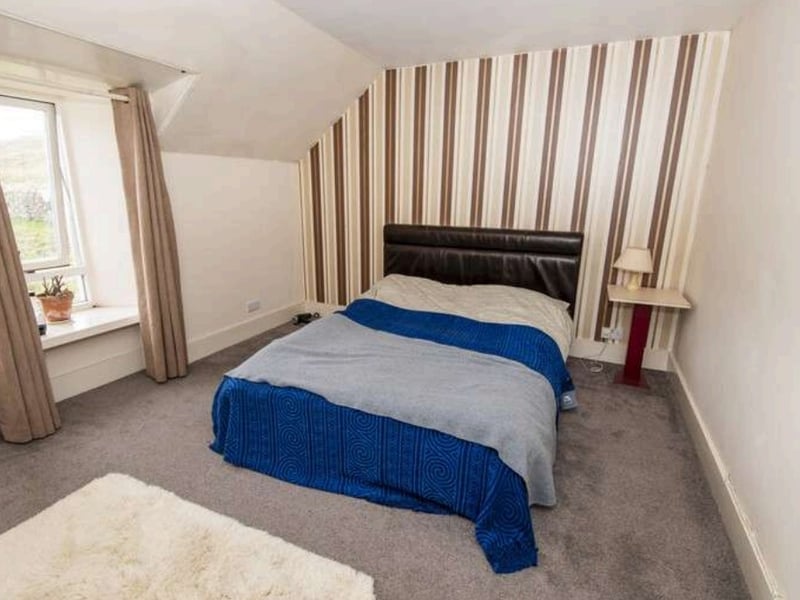 A photo of one of the three bedrooms in the property, which is a two story building
