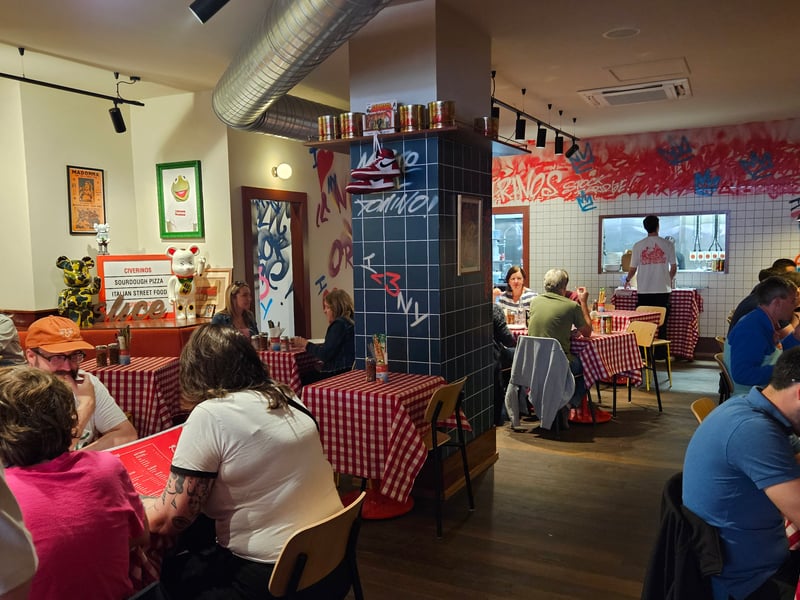 The new restaurant has a sleek red and white design inside, with traditional, checked table cloths that take customers back in time.