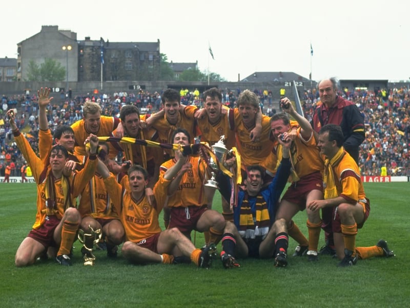 A victorious Motherwell team celebrate with the trophy after winning the Scottish Cup final against Dundee United at Hampden Park in 1991.