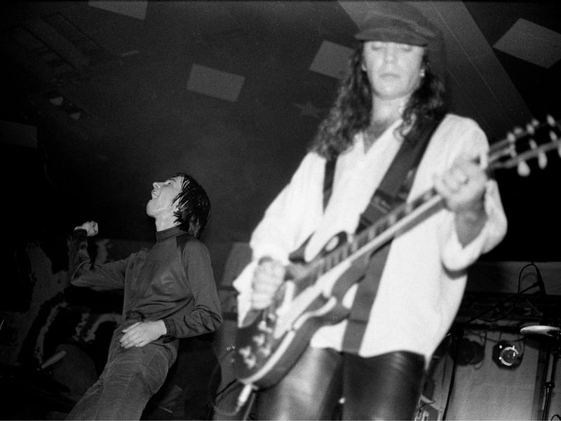Bobby Gillespie and Robet 'Throb' Young of Primal Scream perform on stage at the Barrowland Ballroom in October 1991. 