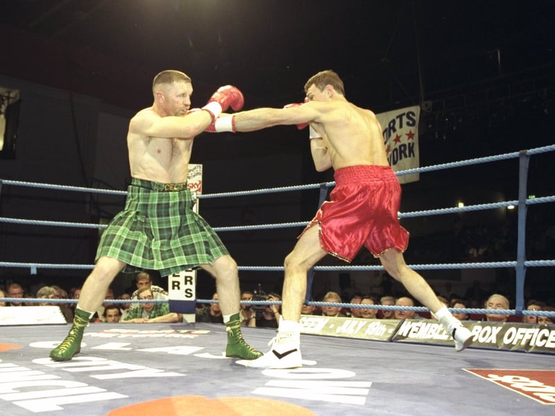 Steve Collins (left) of Ireland blocks a punch from Craig Cummings of the USA during the WBO Super Middleweight Championship in Glasgow.