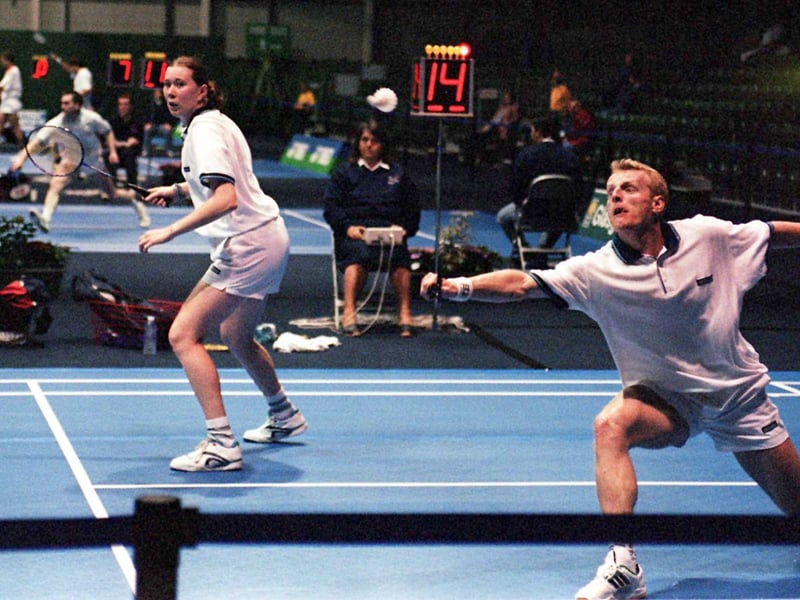 French teammates Sandrine Lefevre (L) and Manuel Dubrulle as he hits the shuttlecock during the first round of the World Badminton Championships in Glasgow.