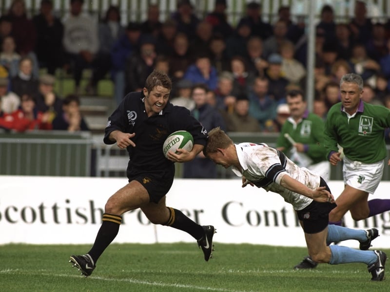 Andy Gomarsall (left) of Wasps evades the tackle of Fraser Stott (right) of Glasgow during the Heineken European Cup match at the Scotstoun Stadium.
