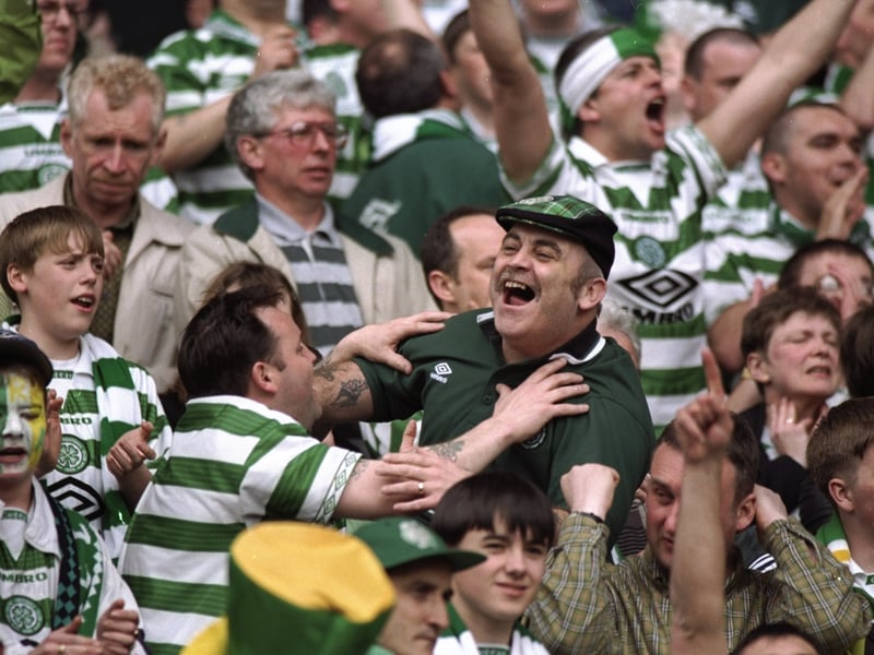 Celtic fans celebrate after a Scottish Premier League match against St Johnstone in 1998.