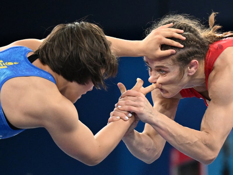 Azerbaijan's Mariya Stadnik (R) wrestles Mongolia's Otgonjargal Dolgorjav (L) in their women's freestyle 50kg wrestling quarter-final match