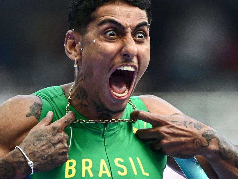 Brazil's Gabriel Dos Santos reacts after competing in the men's 4x100m relay heat of the athletics event