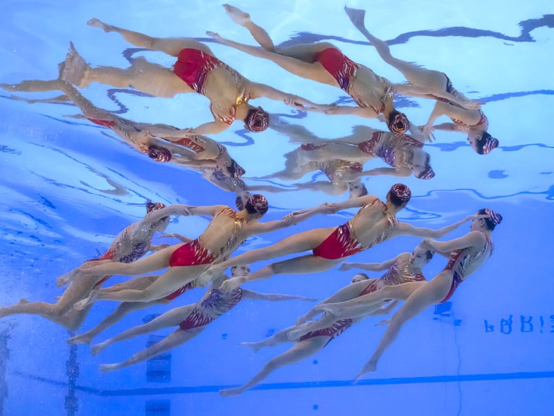 An underwater view shows Team China competing in the team acrobatic routine of the artistic swimming event