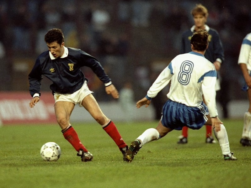 John Collins gets past Joerg Stuebner of East Germany during a Friendly match at Hampden Park in April 1990. 