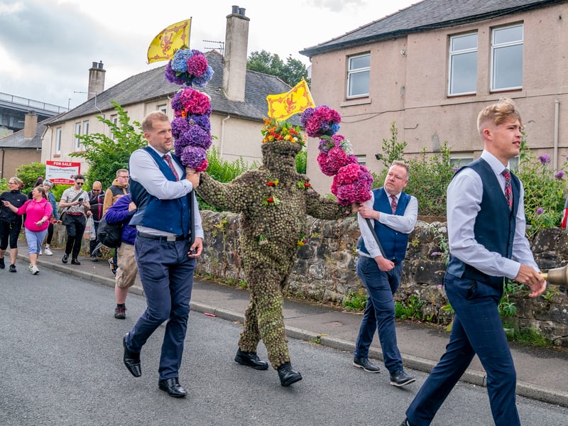Burryman Andrew Taylor parades through the town of South Queensferry, near Edinburgh. The age-old ritual is believed to bring good luck