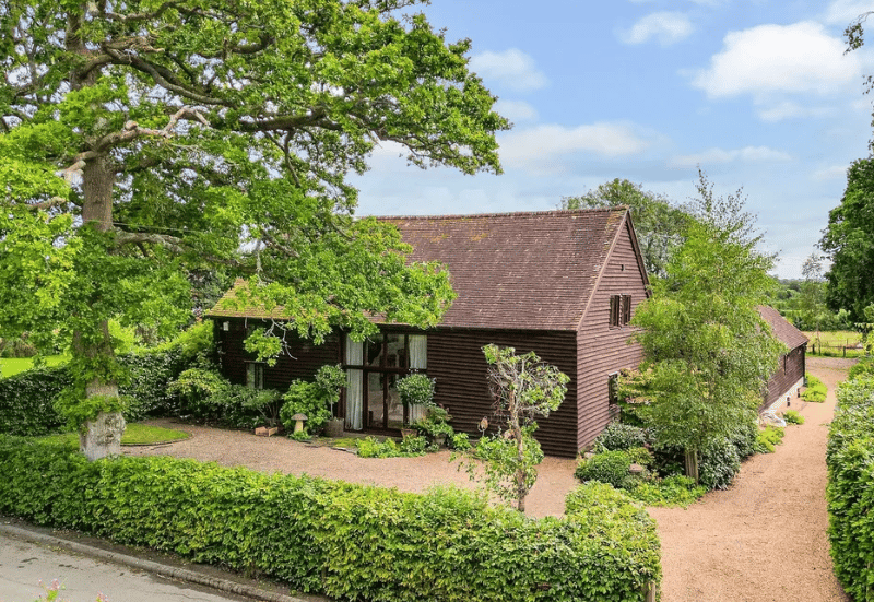 The listing says: "With a perfect combination of charm and character, as well a layout that offers both versatility and flexibility for any growing family, Clarendon Barn is surrounded by countryside and comes with approaching one and a half acres of mature gardens with two adjoining paddocks." 
