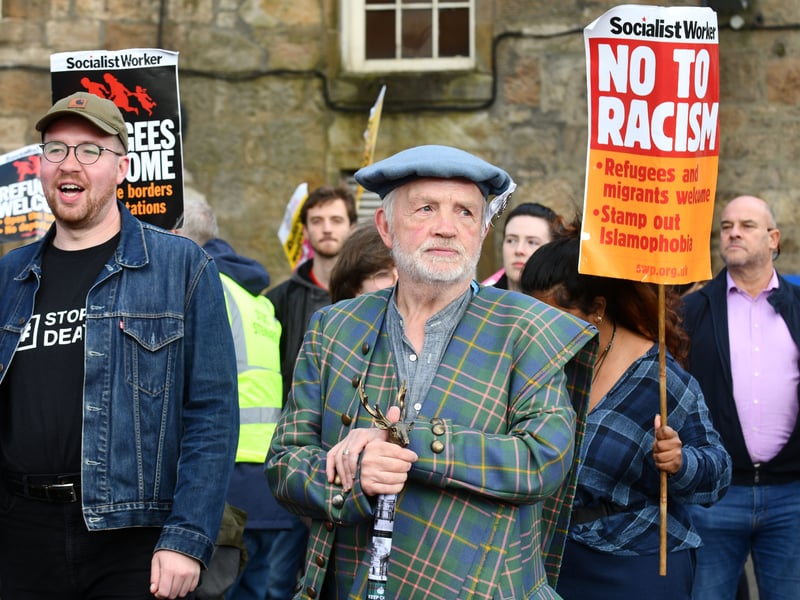 A protester, wearing tartan, joins an estimated 200 people who gathered in Paisley in opposition to the riots that have targeted asylum seekers across the UK
