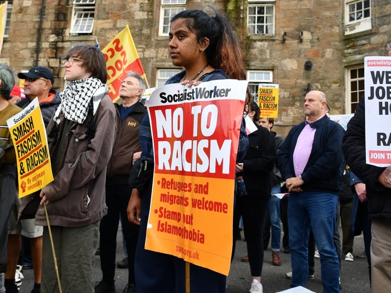 A demonstrator takes a stand in Paisley. About 120 Police Scotland officers soon will travel to Northern Ireland amid disorder there to help bolster the ranks of the Police Service of Northern Ireland