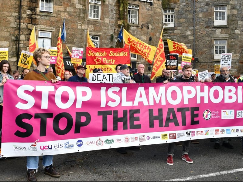 Protesters bearing a banner carrying the words 'Stop Islamophobia, Stop the Hate' gather in Paisley