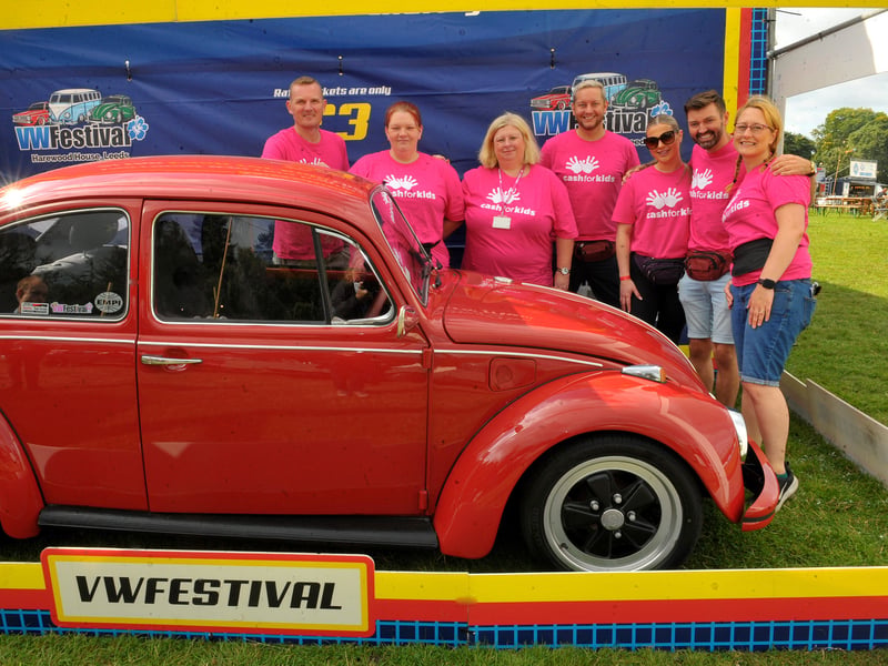 Staff and volunteers of Cash For Kids with the beetle renovated by the Beetle Hospital which was first prize in the raffle. This is the ninth car they have raffled at the festival raising over £100,000 for disadvantaged kids in Yorkshire. (pic by Steve Riding / National World)