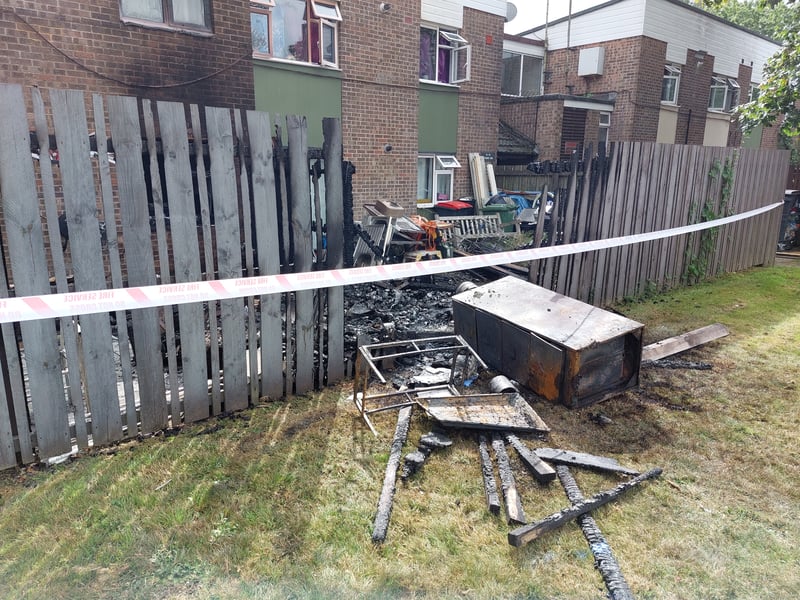 The fire started in a shed and spread to the fence and flats next to it.