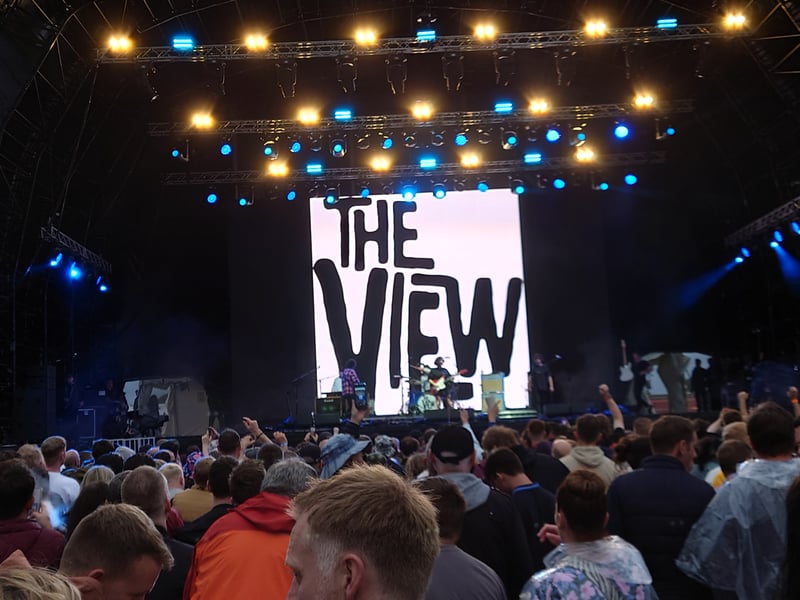 The View started their set with rocker 'Grace' and went straight into 'Wasted Little DJ's' to help the crowd warm up, with chilly winds and occasional rain making a mockery of the festival's name at times. More bounce-along tunes followed including 'Tragic Magic' as the strengthening wind briefly threatened to ruin the sound. The crowd then joined in for a singalong for a stripped back version of 'Face for the Radio'. 'Double Yellow Lines had the crowd bouncing again, along with 'Sunday', 'Same Jeans', 'Superstar Tradesman' and final track 'Shock Horror'/ 'Typical Time'.