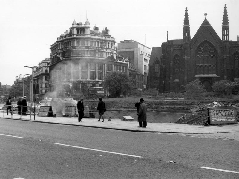 A photo taken in Park Row looking across to demolition work in progress. At the left edge is the General Post Office building fronting City Square. Next to it is the junction with Infirmary Street and in the centre the Norwich Union building stands on the corner with Park Row. At this time the Royal Exchange buildings at the junction with Park Row and Boar Lane were in the process of being demolished. These buildings dated from 1875 and were replaced in 1965 by Royal Exchange House, now refurbished as the Park Plaza Hotel. On the right, is Mill Hill Chapel with part of Priestley House seen to the left of it.