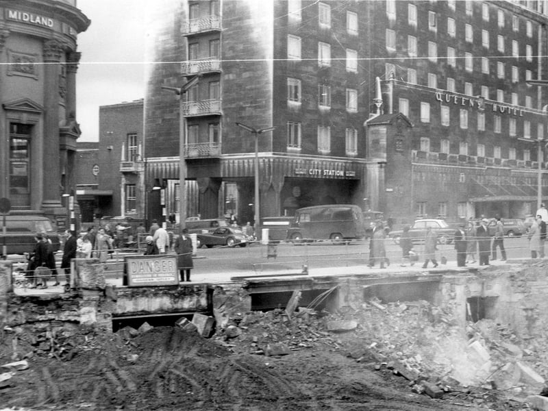 View from the demolition site of the 1875 Royal Exchange buildings, at the junction with Boar Lane and Park Row. At the left hand side, at the junction with Boar Lane and Bishopgate Street, is the Midland Bank Building. The multi-storey building is the Queen's Hotel on Wellington Street. The City Station can be accessed between Bishopgate Street and the Queen's Hotel and the access joins New Station Street. Pictured in May/June 1964.
