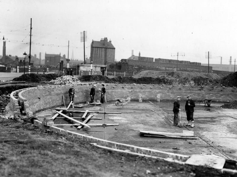 Construction in progress of static water supply tank on Moor Road in October 1942.. Several workmen on site. In the background can be seen goods wagons on railway.