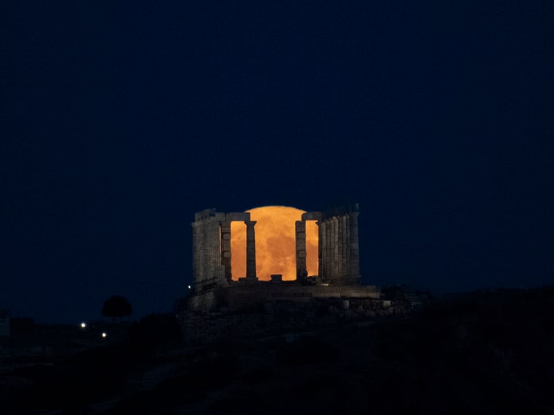 The supermoon rises behind the Temple of Poseidon at Cape Sounio, south of Athens, Monday, Aug. 19, 2024
