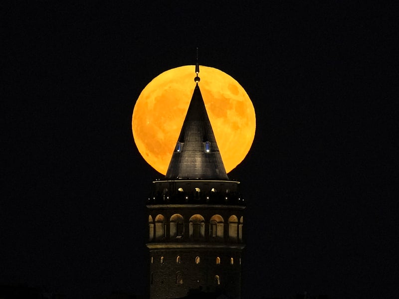 A supermoon rises behind the Galata Tower in Istanbul, Turkey, Monday, Aug. 19, 202