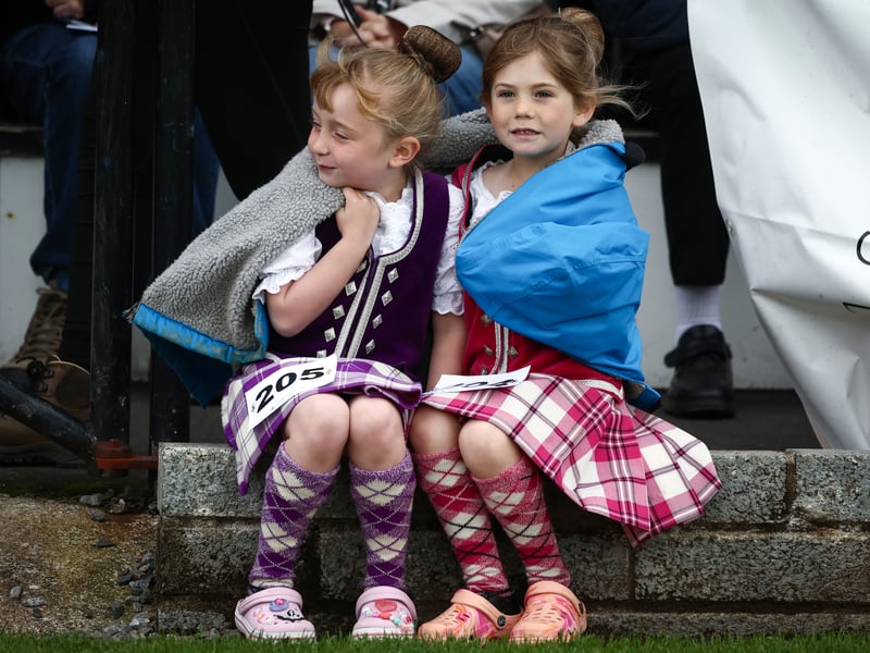 Two dancers keep warm during the Argyllshire Gathering on August 22, 2024 in Oban