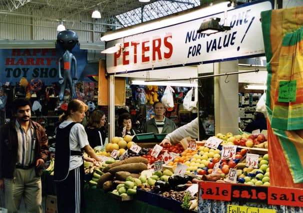 'Peters' Fruit and Vegetable stall in the Kikgate indoor market with produce on display. 'Happy Harry's' Toy stall can be seen on the left. Pictured in October 1999.