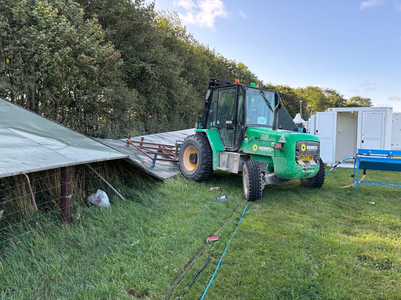 Work is ongoing to rebuild the wall around the festival site after heavy winds struck this morning