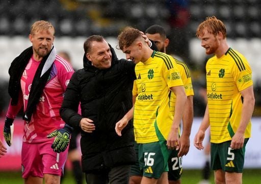 Hoops boss Brendan Rodgers leads debutant Francis Turley over to the travelling Celtic support.
