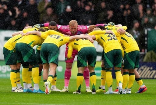 Celtic fans watch on as the team do their traditional huddle before the game. Cr: PA.
