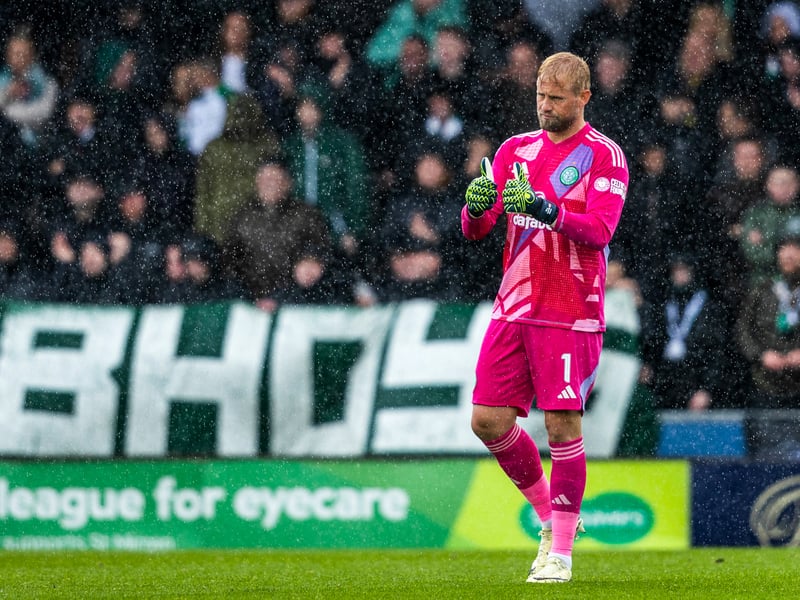 Fans behind Kasper Schmeichel's goal cheer the Celtic team on.