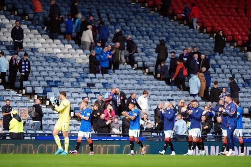 Rangers players applaud supporters who have stayed to praise them after the dominant win.