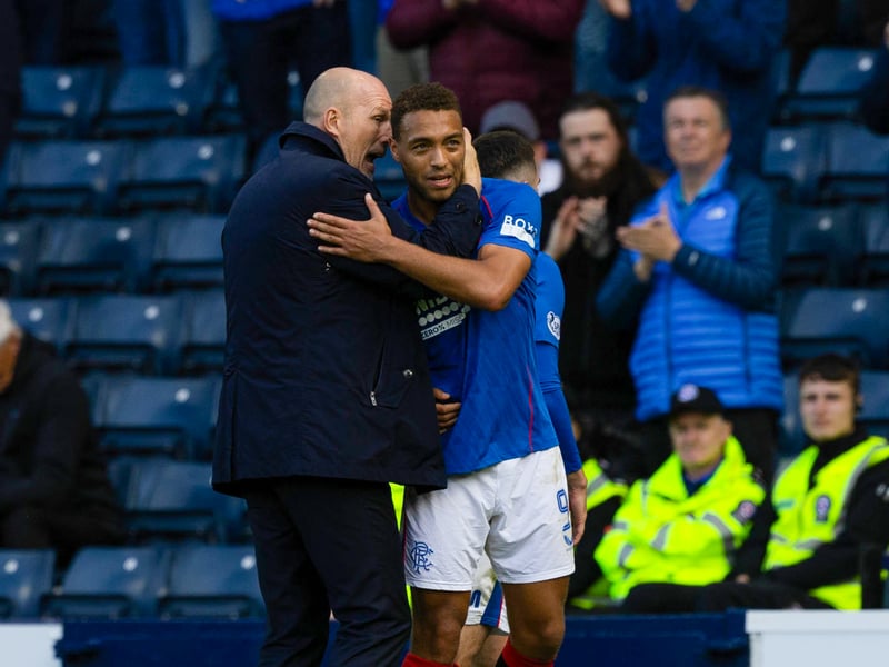 Two goal Cyriel Dessers is given words of praise as Rangers supporters look on.