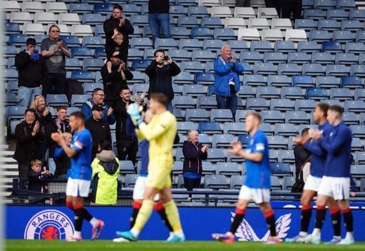 Rangers players salute the fans who have stayed behind to congratulate them on a big win.
