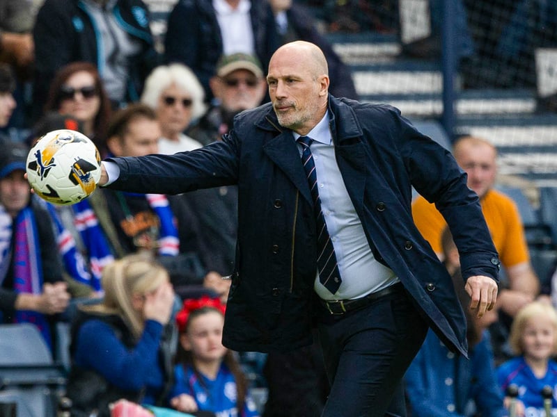 Rangers head coach Phillipe Clement catches the ball as supporters watch on.