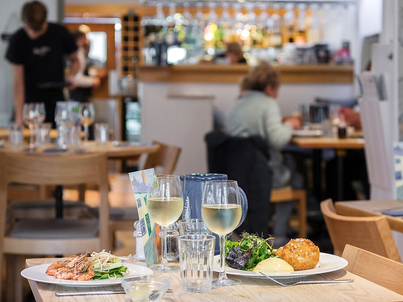 Rick Stein’s Café is located in Padstow, Cornwall. The Good Food Guide says: “As you might expect, the kitchen majors in seafood from the Padstow boats, so dip into an assortment of Rick Stein’s greatest hits at user-friendly prices. Briny freshness and globetrotting flavours collide in classics such as Thai fishcakes, mussels with black beans, garlic and ginger or grilled hake with spring onion mash and soy butter.”