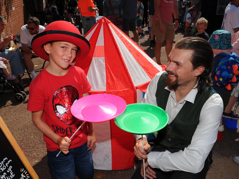 Duncan Flames of Circus Leeds shows tricks to Billy Gallagher, seven, of Chapel Allerton.